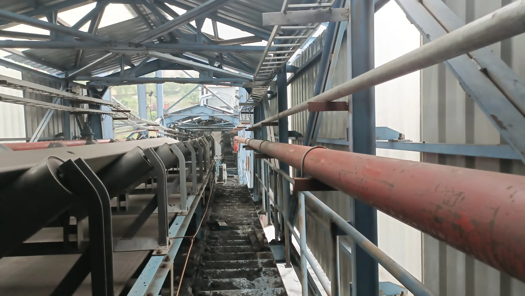 Fire fighting piping network installed along an industrial conveyor walkway