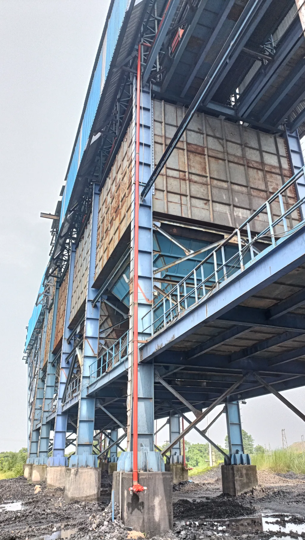 Large industrial structure with vertical fire protection riser pipe installed by Ignispin